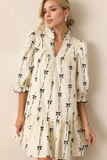 Cream and black bow print mini dress with frill details and half sleeves.