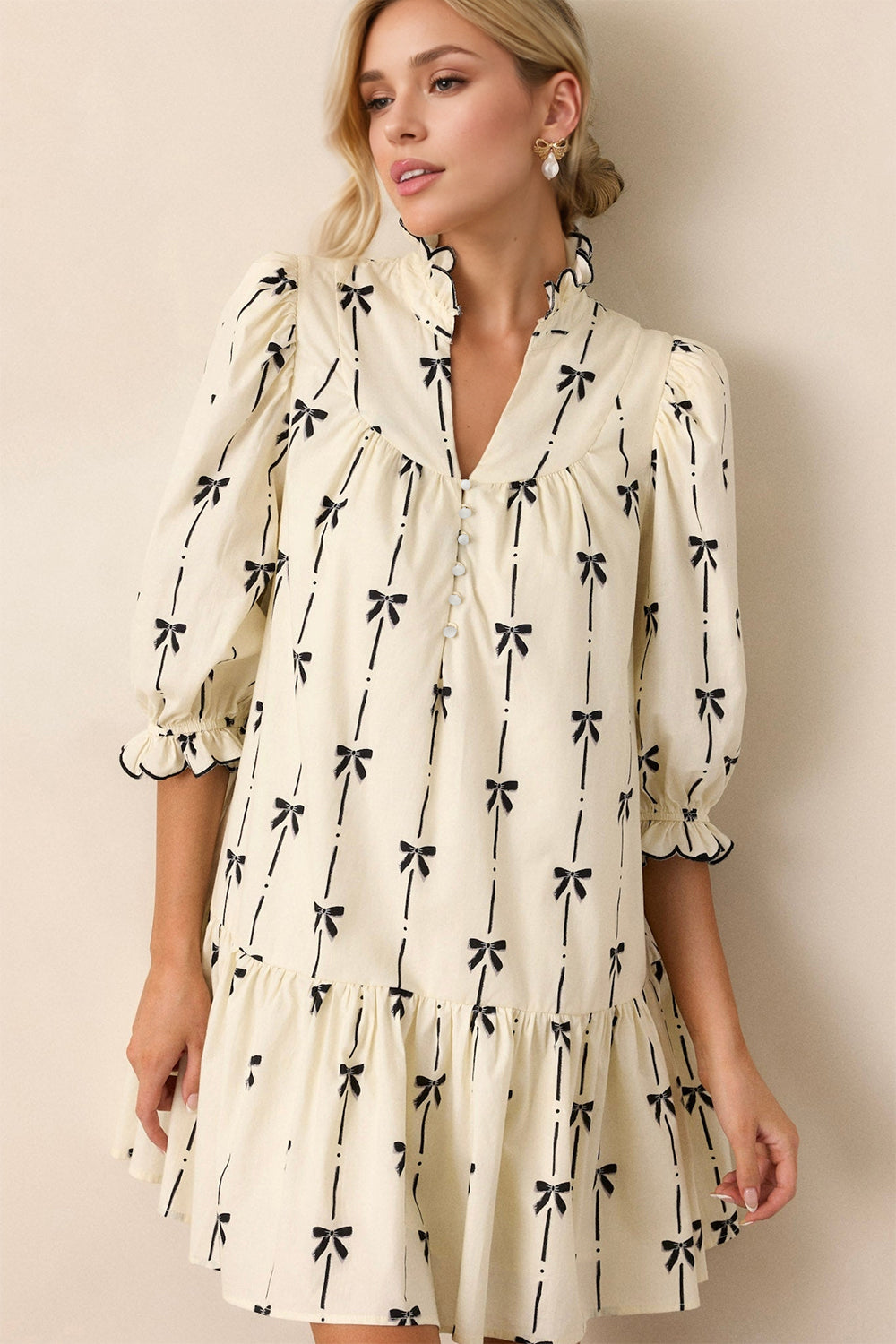 Cream and black bow print mini dress with frill details and half sleeves.