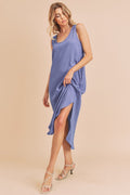 A woman wearing a comfortable round neck midi tank dress with side pockets