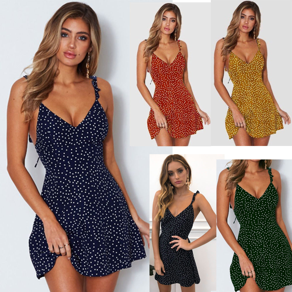 Model wearing a navy blue polka dot mini sundress with ruffle straps, available in multiple color variations.