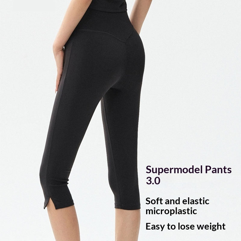 Woman wearing high-waist 7/8 slim-fit yoga leggings in solid color for a sporty workout look.