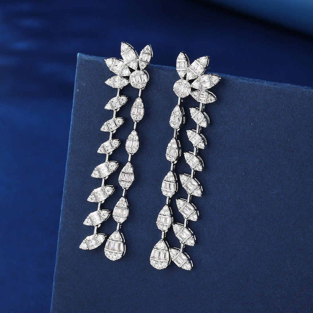 Glamorous floral-inspired silver leaf earrings featuring sparkling pave cubic zirconia and double-chain details