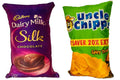 Two reversible kids' throw cushions featuring Dairy Milk Silk and Uncle Chips snack designs.