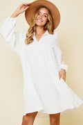 Woman wearing a chic mini dress with a Johnny collar and voluminous balloon sleeves.