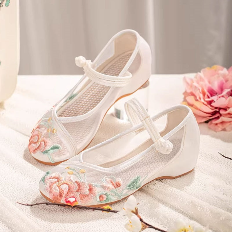 Close up of floral embroidered mesh retro flats with pink and orange petal details