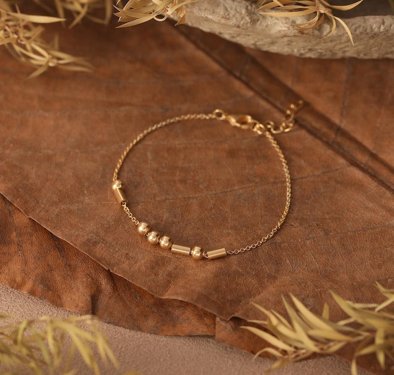 Minimalist Morse Code custom name bracelet with silver-tone beads against a clean background