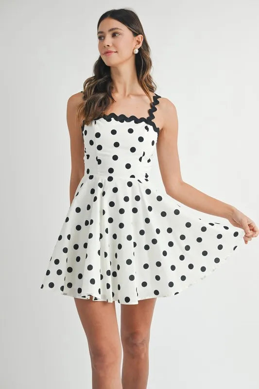 A whimsical polka dot mini dress with ricrac trim straps, perfect for a summer aesthetic.