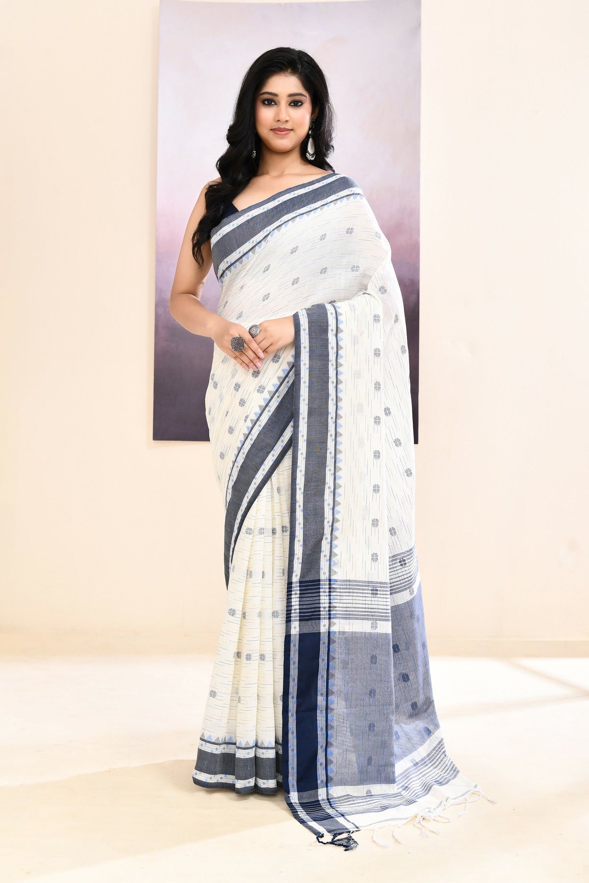 Pristine white cotton saree with elegant embellishments
