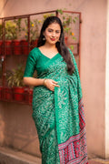 Green silk blend saree with Ajrakh pallu and bhandi prints