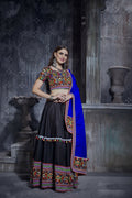 Woman wearing a black art silk designer lehenga choli with a multi-colored blouse for Navratri