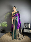 Elegant purple Banarasi soft silk saree with traditional woven patterns and matching blouse.