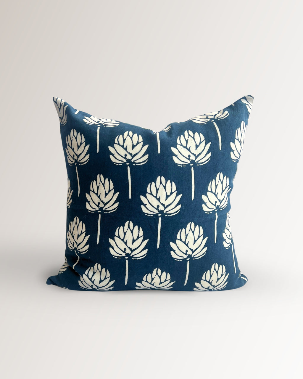 Navy blue linen throw pillow cover with white lotus flower screen print pattern.