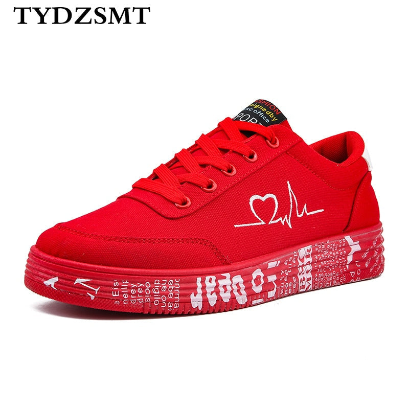 Harajuku style lace-up vulcanized sneakers in red and black featuring a heart pulse print and graphic midsole design.