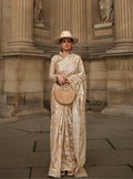 Elegant cream Lakhnavi organza saree featuring detailed weaving and included blouse.