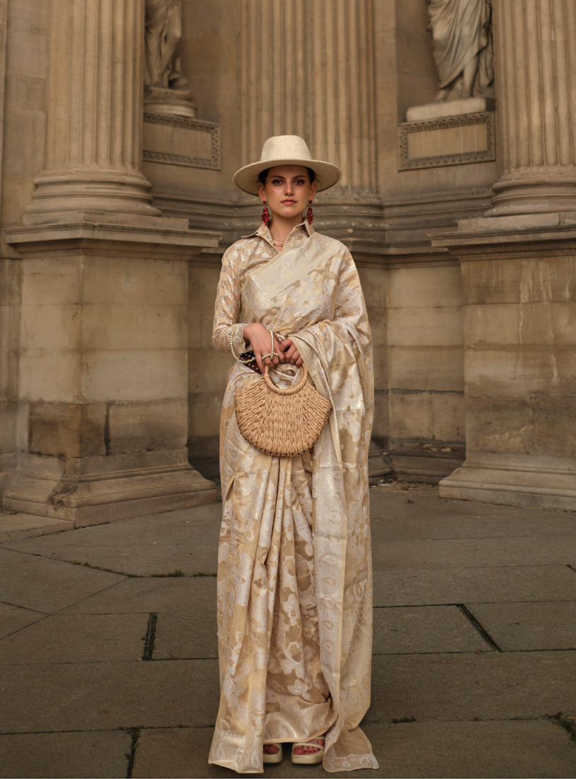 Elegant cream Lakhnavi organza saree featuring detailed weaving and included blouse.