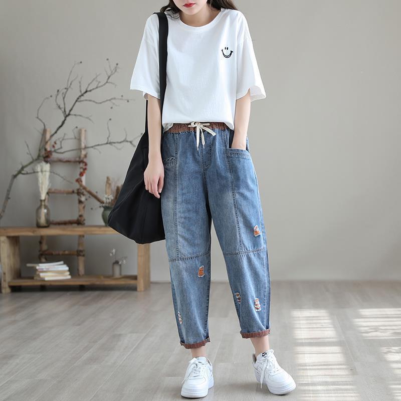 Women's casual ripped denim jeans featuring a drawstring waist and relaxed fit