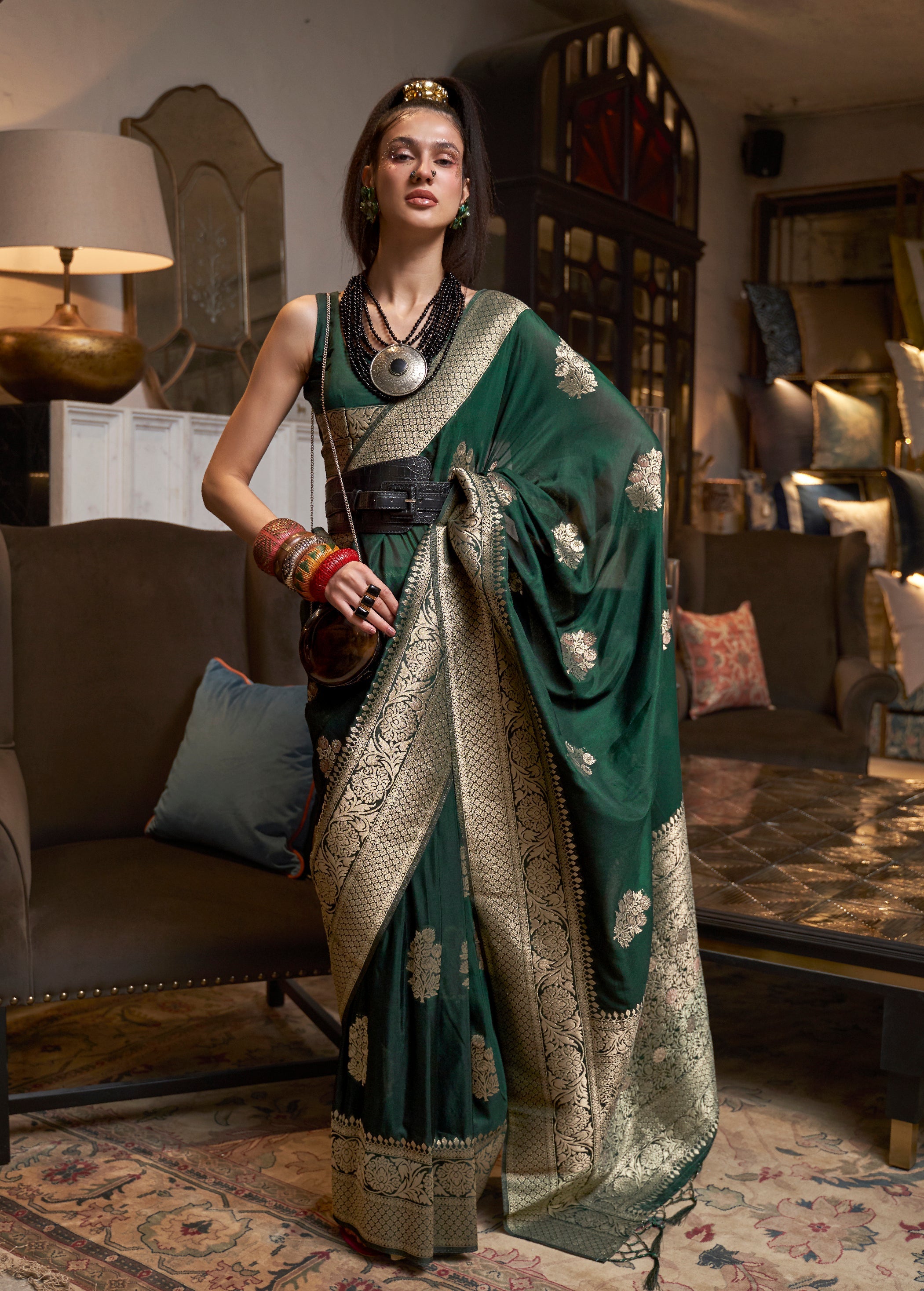 Dark green Khadi Georgette traditional saree with gold Zari weaving detail.