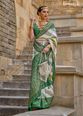 Green silk saree with intricate geometric woven border and matching blouse