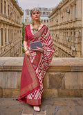 Maroon silk saree highlighting the detailed geometric weaving border design.