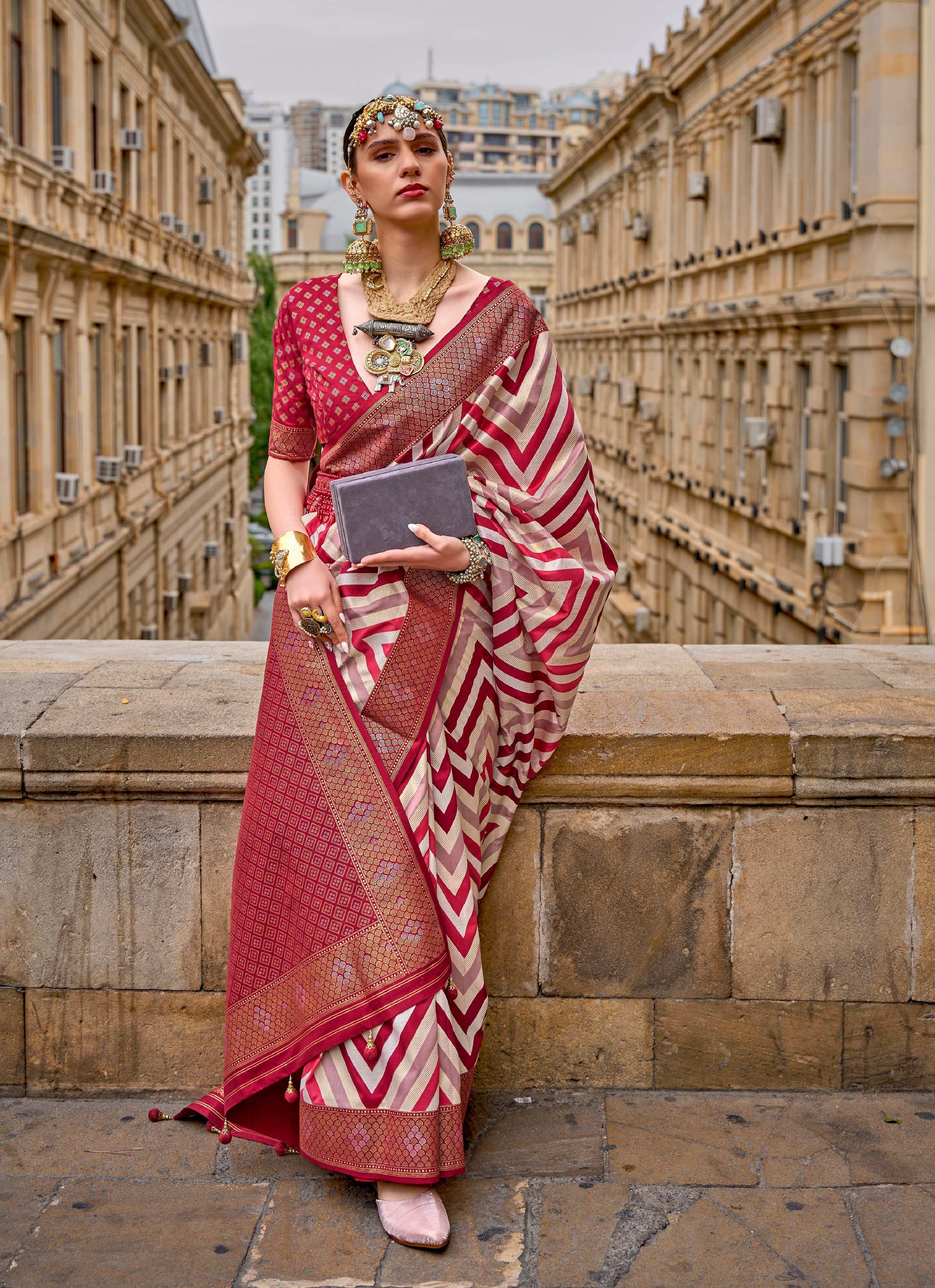 Maroon silk saree highlighting the detailed geometric weaving border design.