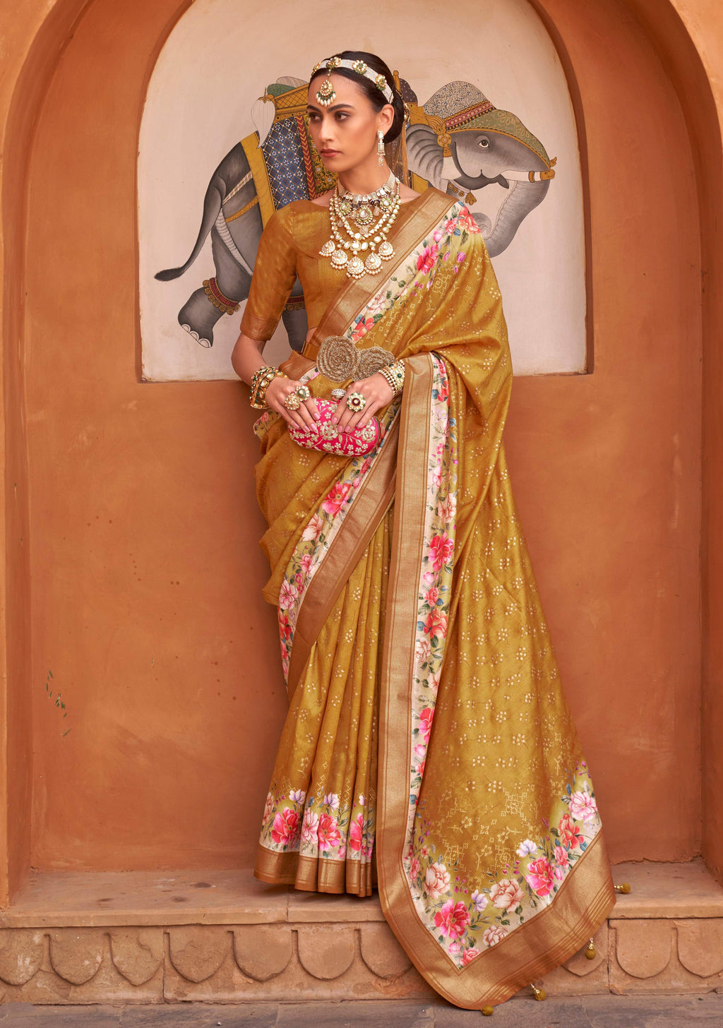 Amber color digitally printed silk saree featuring a floral pattern with an included blouse piece.