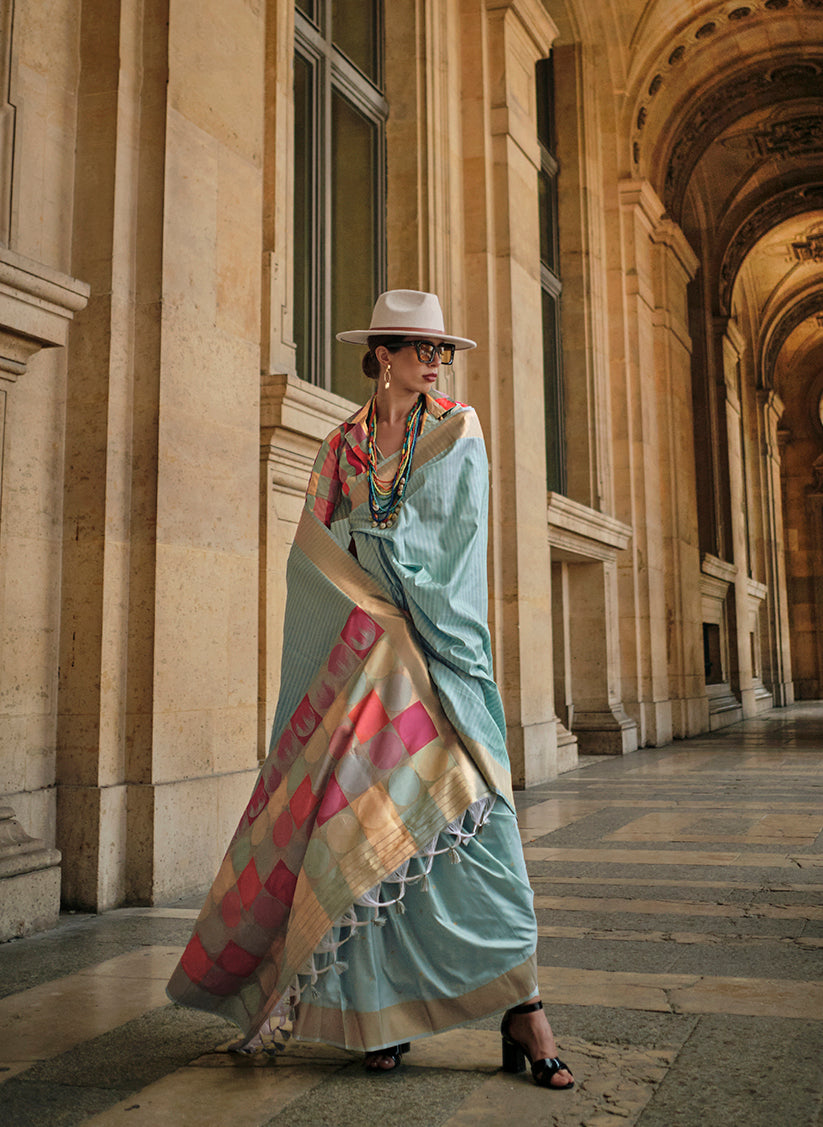 Elegant light sky blue soft silk ceremonial saree with smooth flowing fabric texture.