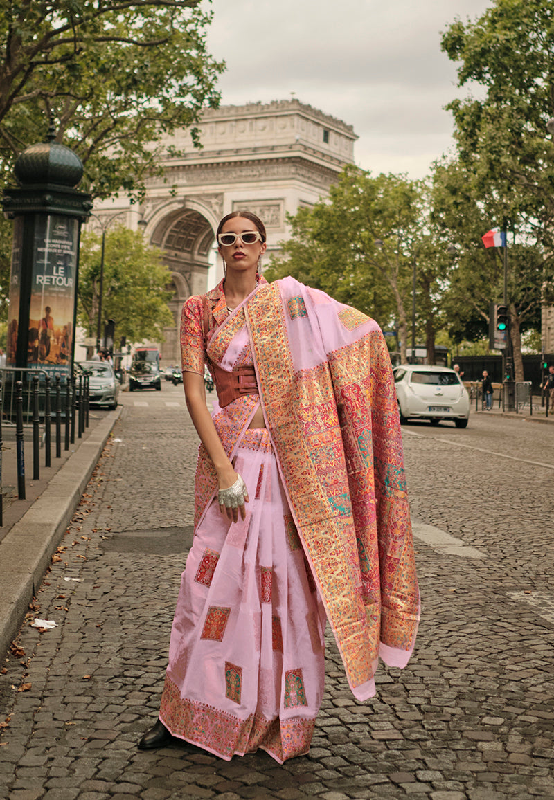 Elegant light pink woven silk saree with traditional border for festive events