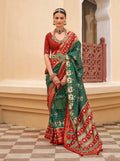 Dark Green Sigma silk saree featuring intricate Patola prints and matching blouse