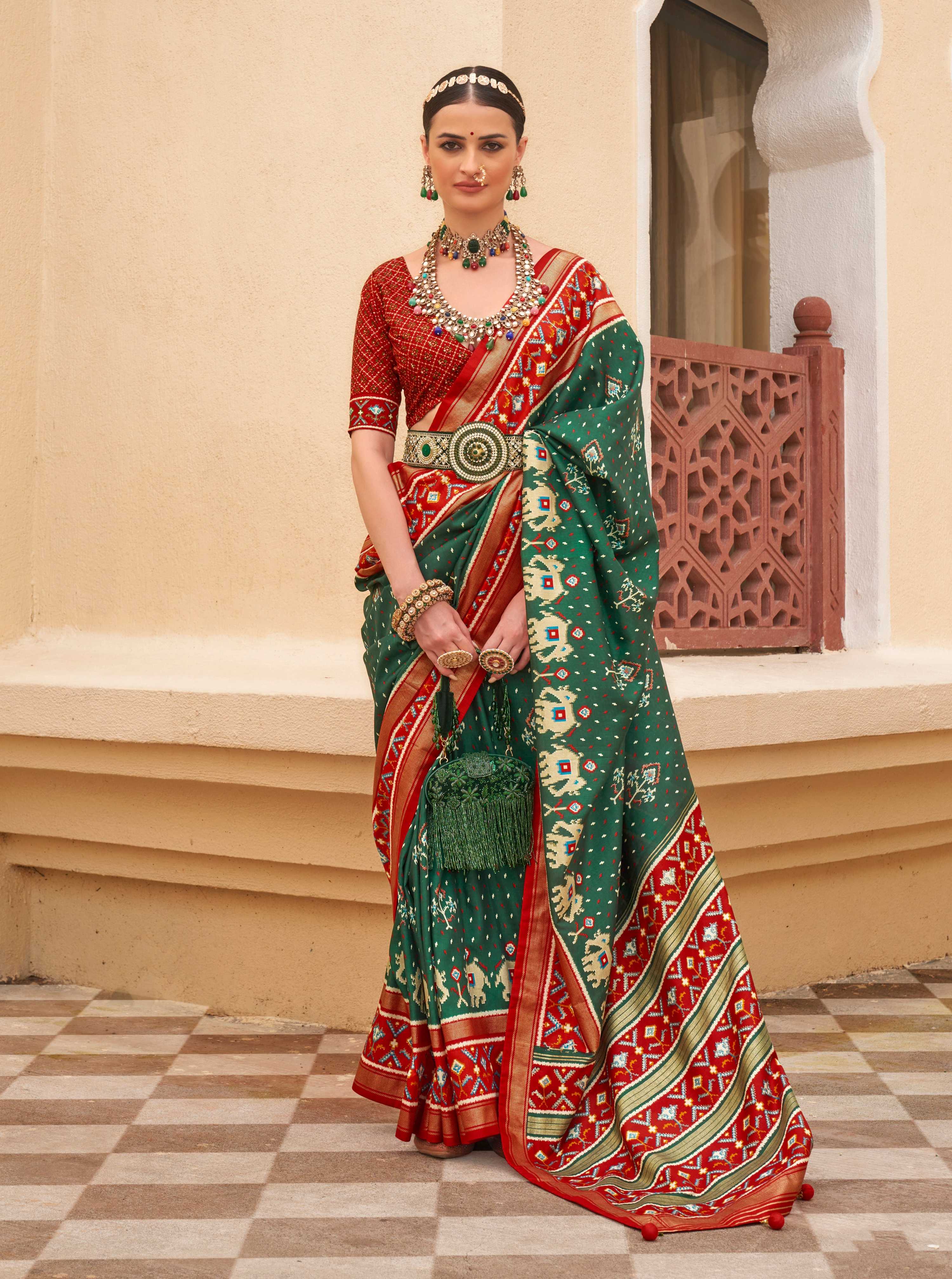 Dark Green Sigma silk saree featuring intricate Patola prints and matching blouse