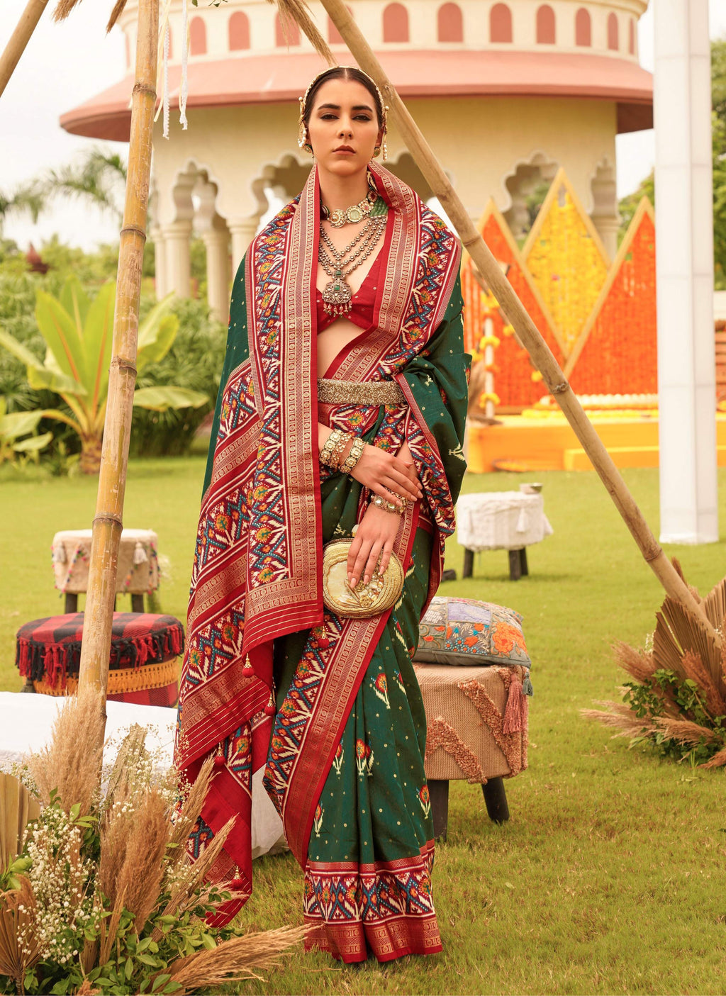 Dark green Sigma silk saree featuring intricate Patola patterns with matching blouse