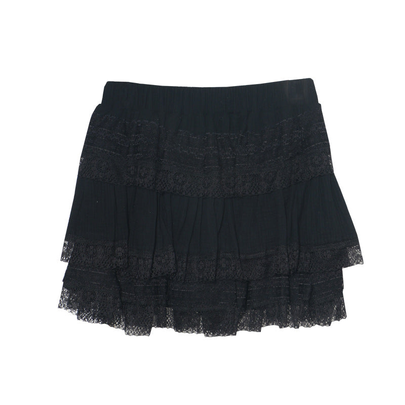 Black lace tiered mini skirt with elastic waistband, displayed alongside a white version on hangers, embodying Harajuku style.