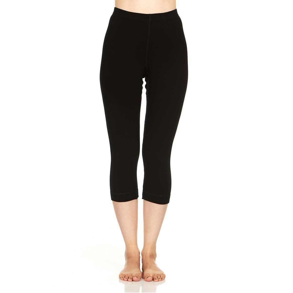Women's 3/4 length black merino wool ski base layer leggings with a tapered fit