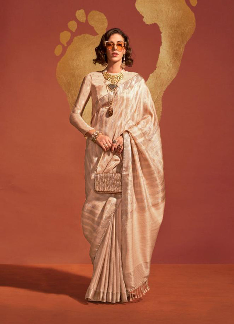 Beige viscose handloom silk saree featuring intricate traditional weaving patterns.