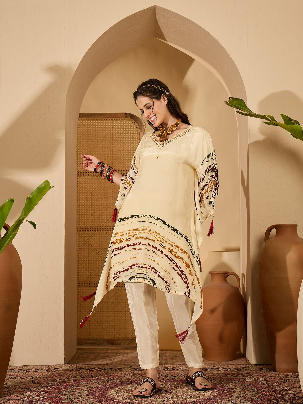 Cream silk kaftan-style kurta set with an artistic print