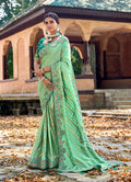 Sea green Banarasi silk saree with intricate embroidery and matching blouse.