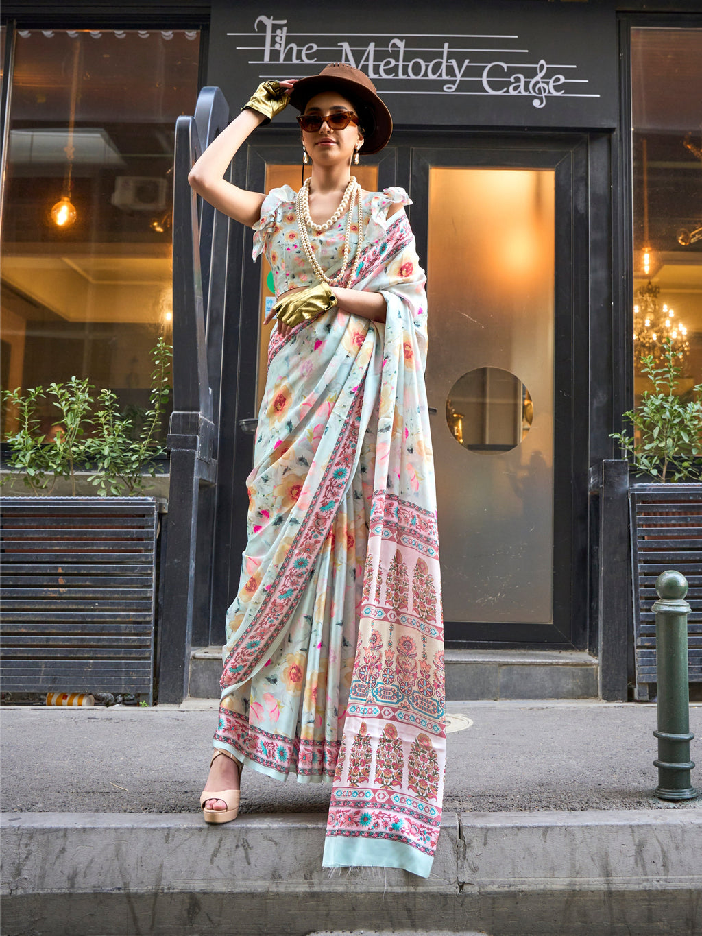 Model draped in an off-white satin georgette designer saree