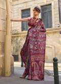 Lightweight wine-colored satin georgette saree featuring a smooth, flowing drape.