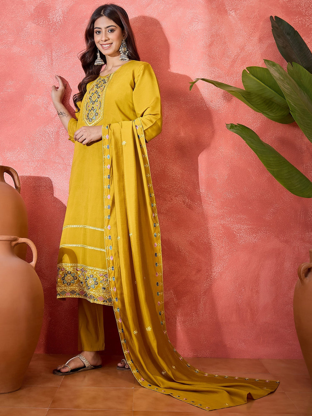 Mustard yellow silk kurta set with intricate embroidery at the neckline