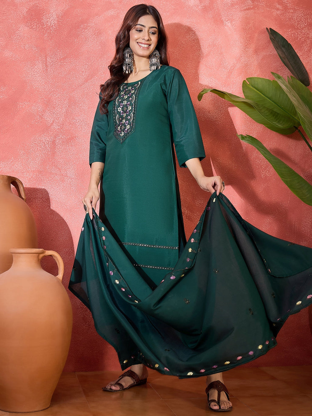 Elegant emerald green silk kurta set with intricate embroidery and round neckline