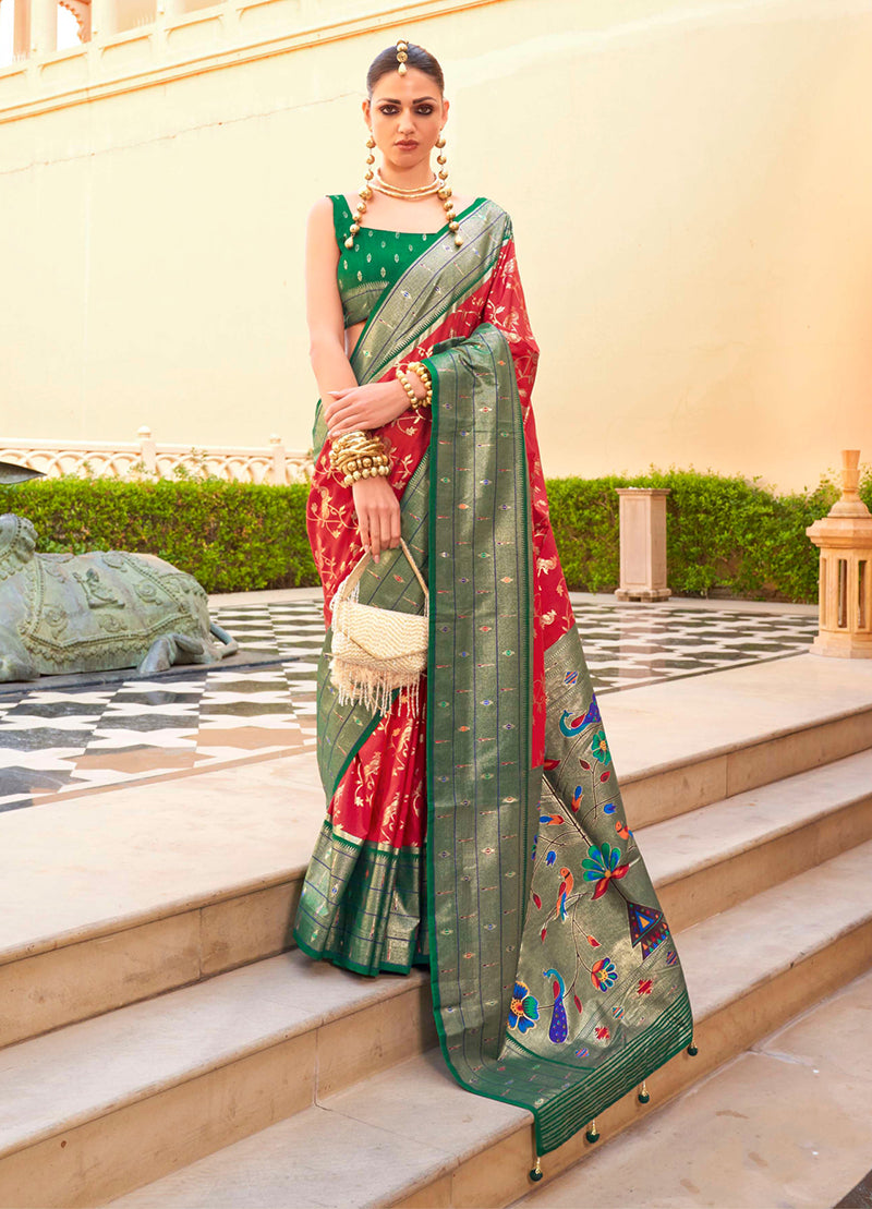 A beautiful crimson soft silk saree with traditional Paithani weaving motifs and gold detailing.