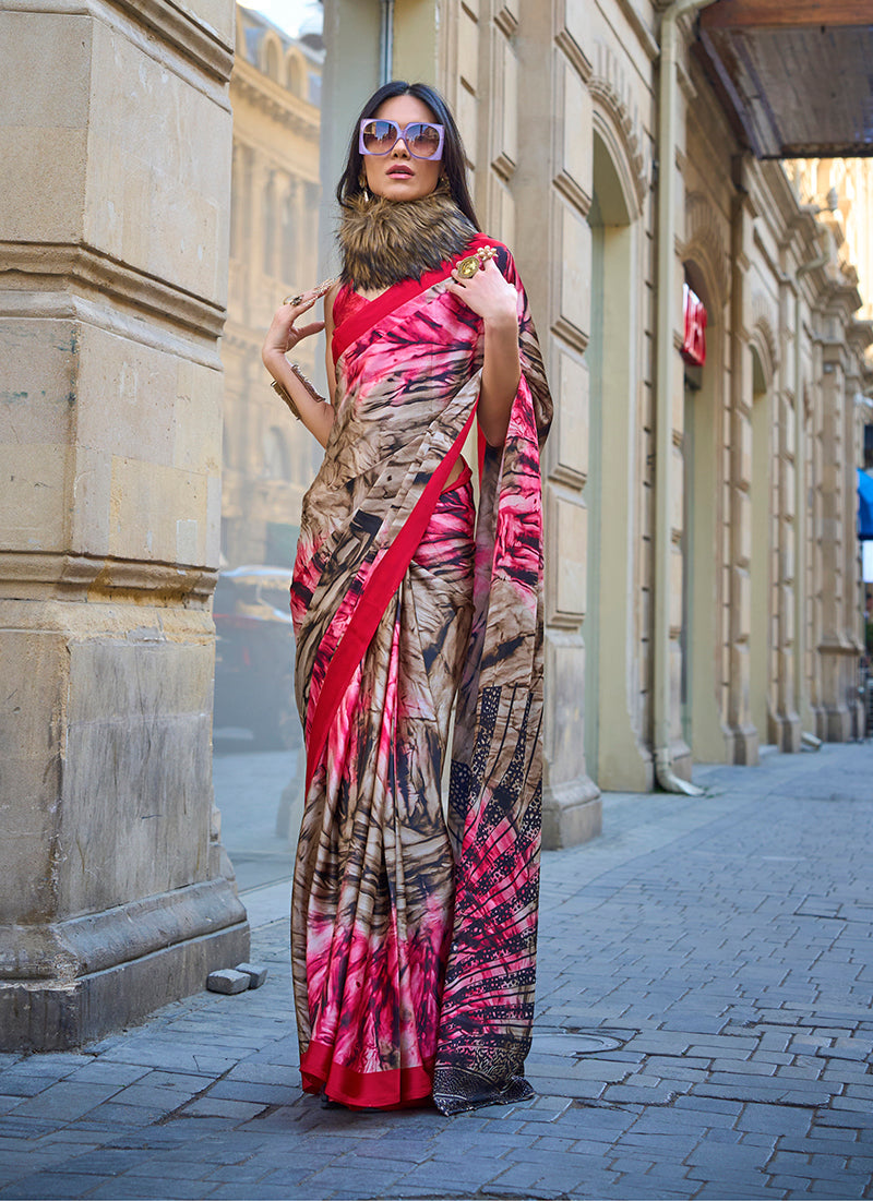 A glamorous multi-coloured satin silk saree with modern abstract prints in red, brown, and black.
