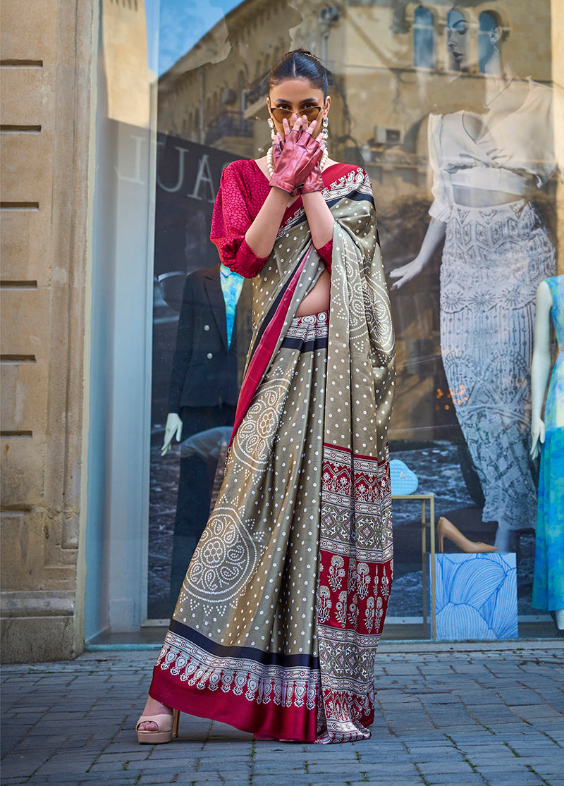 Woman wearing a light brown satin silk printed saree with a smooth, luxurious finish.