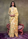 A light yellow printed Mulmul cotton saree displayed with a soft, lightweight drape.