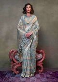 Slate grey mulmul cotton saree with intricate patterns and soft drape
