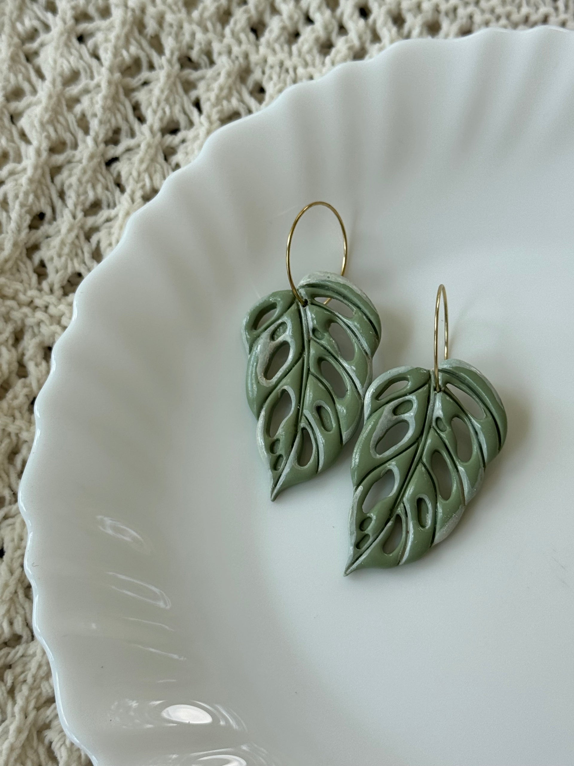 Handmade sage green polymer clay Swiss Cheese Leaves earrings with gold-plated hooks