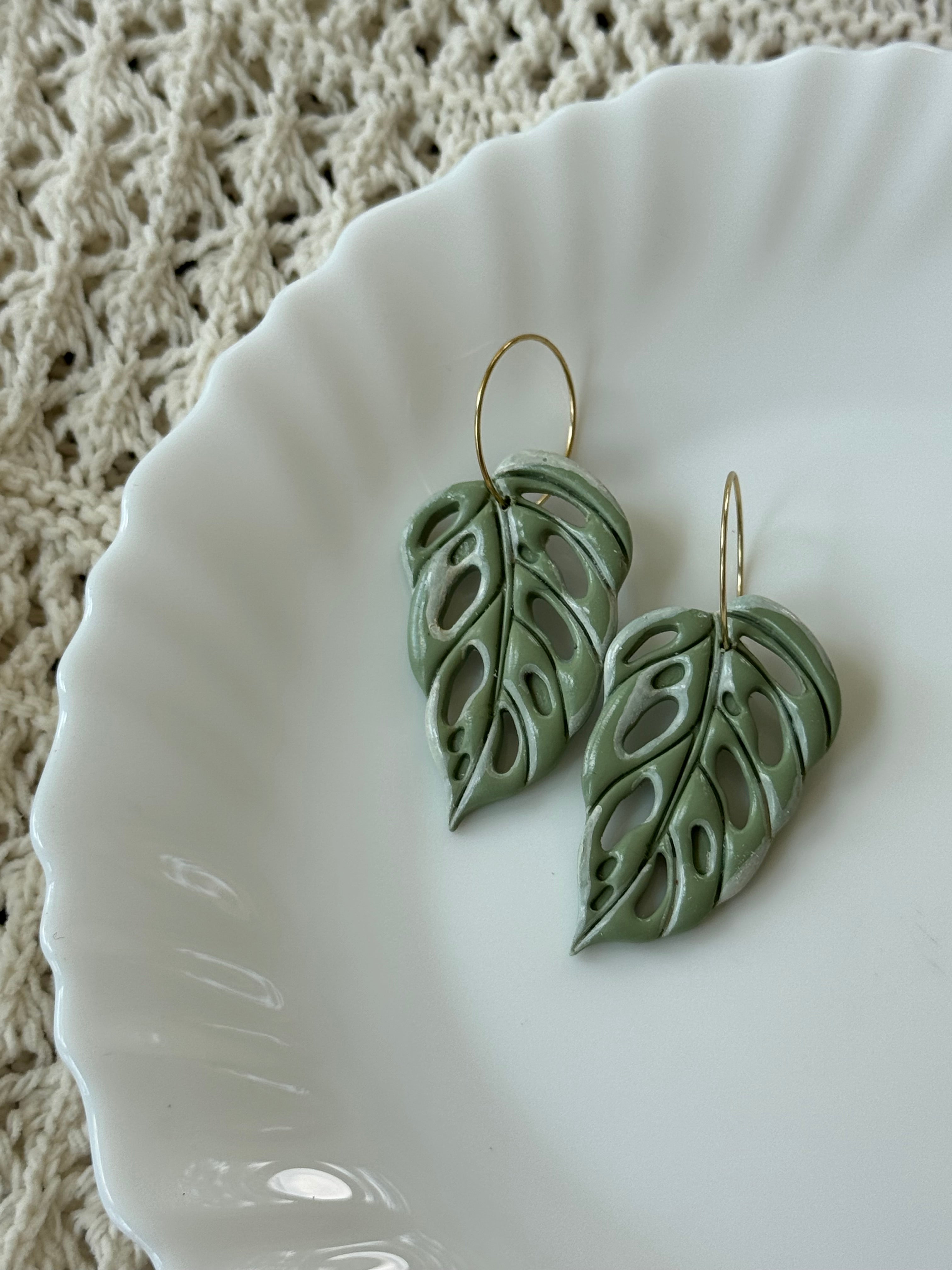 Handmade sage green polymer clay Swiss Cheese Leaves earrings with gold-plated hooks