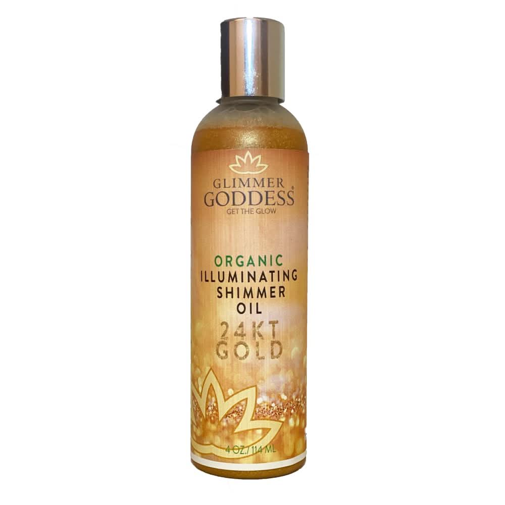 Close up of 24KT Gold Illuminating Shimmer Oil bottle with golden glow highlights on skin