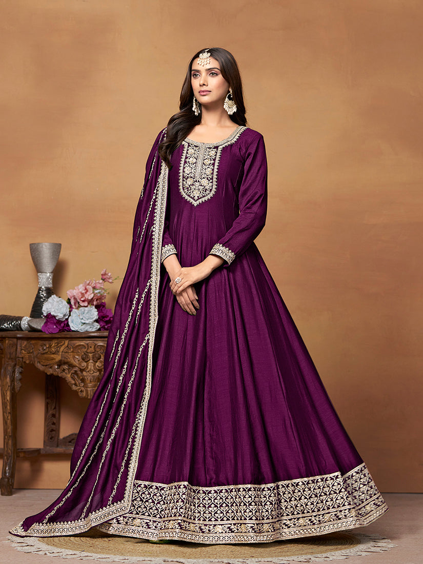 Purple art silk Anarkali dress featuring intricate gold zari embroidery and traditional silhouette