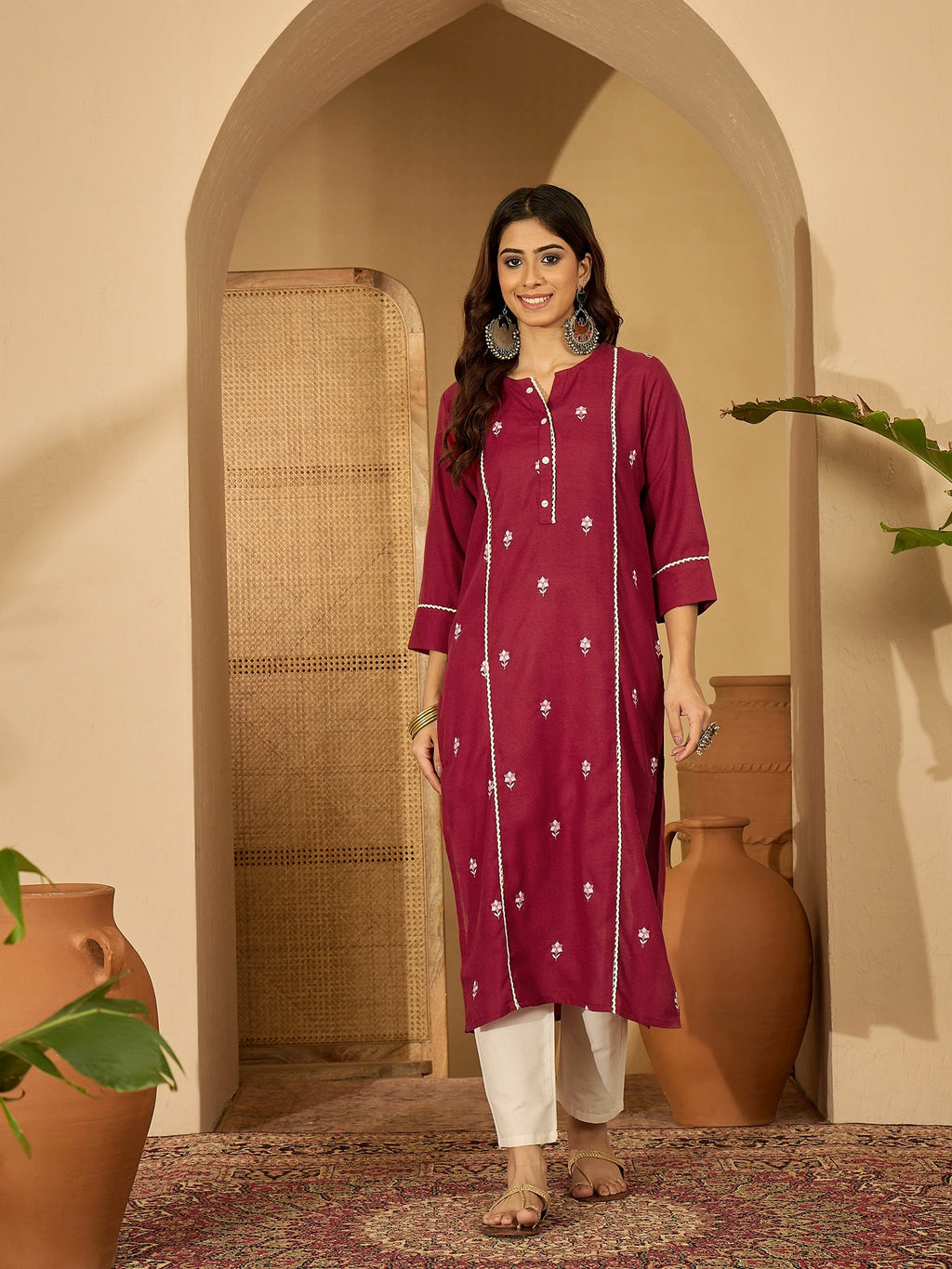 Maroon viscose rayon tunic featuring intricate embroidery, worn as a chic festive kurti