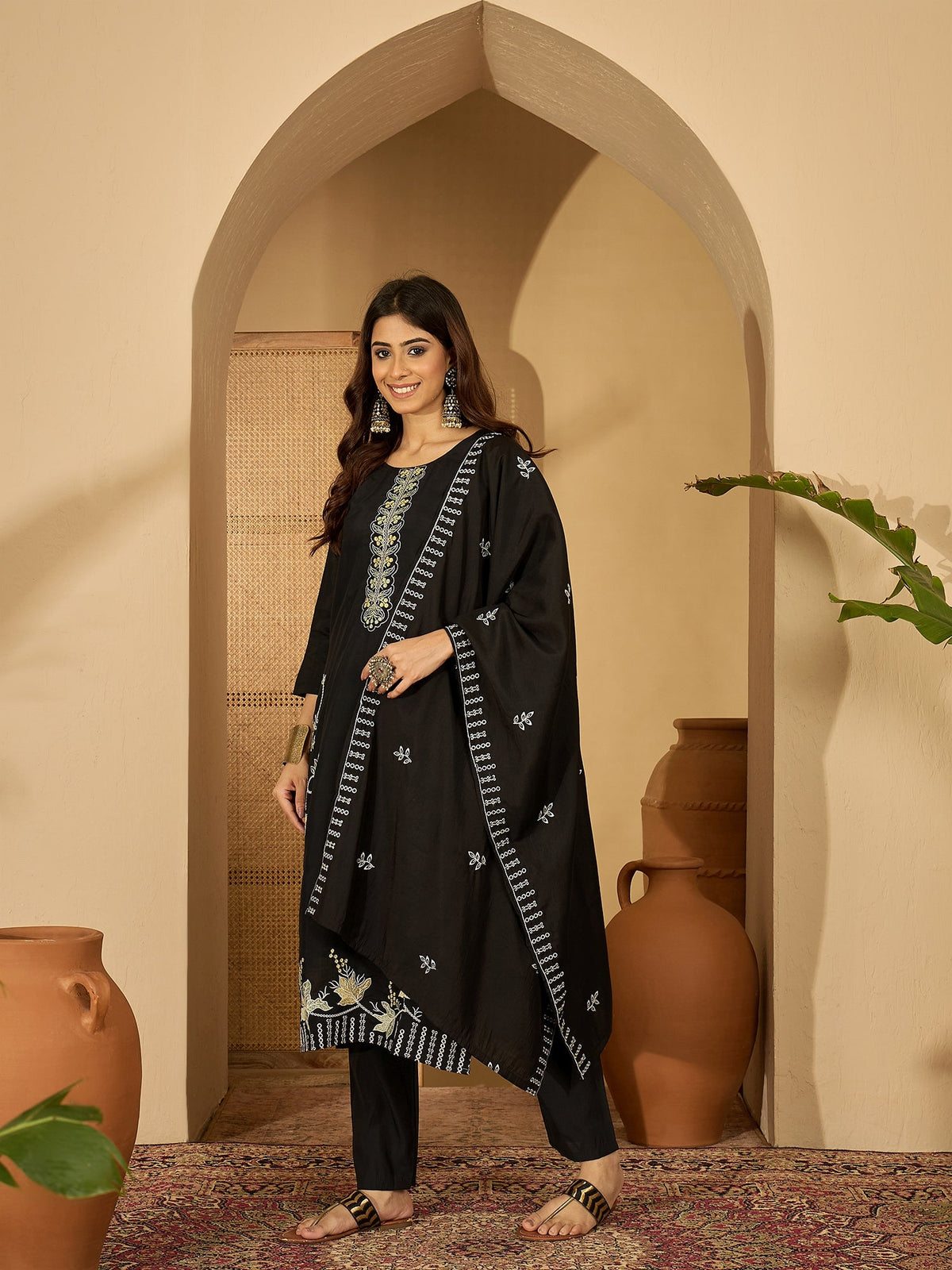 Elegant black silk kurta for women featuring intricate embroidery on the round neckline.